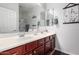 Bright bathroom with double sinks, spacious countertop, and decorative accents at 15456 W Corrine Dr, Surprise, AZ 85379