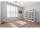 Bright, neutral-toned bedroom with a large window and modern shelves providing ample storage and natural light at 15456 W Corrine Dr, Surprise, AZ 85379