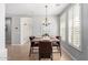 Charming dining room with a chandelier, modern table setting, and shuttered windows at 15456 W Corrine Dr, Surprise, AZ 85379