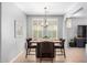Stylish dining room with modern furniture, chandelier, and plantation shutters at 15456 W Corrine Dr, Surprise, AZ 85379