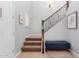 Well-lit foyer featuring a staircase, an art piece, and a cozy bench at 15456 W Corrine Dr, Surprise, AZ 85379