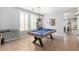 Spacious game room with a pool table, ample lighting, and neutral tones at 15456 W Corrine Dr, Surprise, AZ 85379
