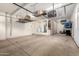 Large garage space with overhead storage racks and built-in cabinets at 15456 W Corrine Dr, Surprise, AZ 85379