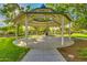 A gazebo in a community park sits on a large concrete pad surrounded by landscaped greenery at 15456 W Corrine Dr, Surprise, AZ 85379
