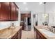 Modern kitchen featuring stainless steel appliances, granite countertops, and ample cabinet space at 15456 W Corrine Dr, Surprise, AZ 85379