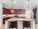 Bright kitchen boasts a sizable island, sleek appliances, and dark wood cabinets at 15456 W Corrine Dr, Surprise, AZ 85379