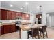Beautiful kitchen showcases an island with seating, granite countertops, and stainless steel appliances at 15456 W Corrine Dr, Surprise, AZ 85379