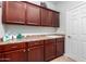 Functional laundry room features cabinetry and a sink for added convenience at 15456 W Corrine Dr, Surprise, AZ 85379