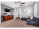 Living room features a dark gray sectional sofa and built in wall unit for a cozy and functional space at 15456 W Corrine Dr, Surprise, AZ 85379