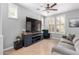 Inviting living room features a large TV, comfortable seating, and shuttered windows at 15456 W Corrine Dr, Surprise, AZ 85379
