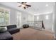 Open loft area with railing, ceiling fan and a dark gray sectional for a cozy second story living space at 15456 W Corrine Dr, Surprise, AZ 85379