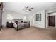 Spacious main bedroom boasts a ceiling fan, neutral colors, and ample natural light from the window at 15456 W Corrine Dr, Surprise, AZ 85379