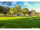 A sprawling park with lush green grass and mature trees creates a serene and inviting recreational space at 15456 W Corrine Dr, Surprise, AZ 85379