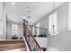 This staircase boasts an open floor plan with a ceiling fan and light filtering window at 15456 W Corrine Dr, Surprise, AZ 85379