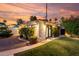 A back house with manicured grass, gravel, plants, and a beautiful sky at 1625 N 11Th Ave, Phoenix, AZ 85007