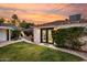 Back house showing well manicured lawn, lush landscaping, and brick exterior at 1625 N 11Th Ave, Phoenix, AZ 85007