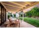 Backyard patio showing outdoor seating, lush landscaping, and mature palm trees at 1625 N 11Th Ave, Phoenix, AZ 85007