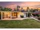 Backyard covered patio with outdoor seating, a well-kept lawn and lush landscaping at 1625 N 11Th Ave, Phoenix, AZ 85007