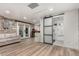 Basement with wood floors, exposed brick wall and sliding glass doors to an ensuite bathroom at 1625 N 11Th Ave, Phoenix, AZ 85007
