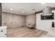Finished basement featuring wood-look floors, decorative brick wall, and recessed lighting at 1625 N 11Th Ave, Phoenix, AZ 85007