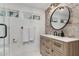 Bathroom featuring vanity, sink, round mirror, exposed brick and white tiled floors at 1625 N 11Th Ave, Phoenix, AZ 85007