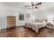 Spacious bedroom featuring hardwood floors, a ceiling fan, and a comfortable queen-sized bed at 1625 N 11Th Ave, Phoenix, AZ 85007