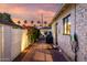 Paver driveway featuring an EV charger and access to the home, surrounded by mature landscaping at 1625 N 11Th Ave, Phoenix, AZ 85007