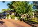 A charming home with a brick driveway, lush flowers, and mature landscaping enhances curb appeal at 1625 N 11Th Ave, Phoenix, AZ 85007