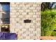 Close-up of brick detail, window, and vintage mailbox on the exterior of this charming home at 1625 N 11Th Ave, Phoenix, AZ 85007