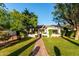 Charming single story home with lush front lawn and mature trees lining a brick walkway at 1625 N 11Th Ave, Phoenix, AZ 85007