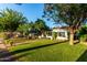 Charming single story home with lush front lawn and mature trees lining a brick walkway at 1625 N 11Th Ave, Phoenix, AZ 85007