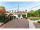 Detached garage featuring flowering bushes and convenient alley access at 1625 N 11Th Ave, Phoenix, AZ 85007
