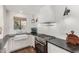 Bright kitchen features white cabinets, a range, dark stone countertops, and hardwood flooring at 1625 N 11Th Ave, Phoenix, AZ 85007
