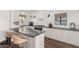 Bright kitchen features a dark stone countertop island with two chairs and stainless steel appliances at 1625 N 11Th Ave, Phoenix, AZ 85007