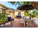 Outdoor patio with brick pavers, comfortable seating, and an umbrella for shade creates inviting backyard oasis at 1625 N 11Th Ave, Phoenix, AZ 85007