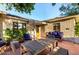 Outdoor patio with brick pavers, wooden table and seating creates inviting outdoor space at 1625 N 11Th Ave, Phoenix, AZ 85007