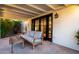 Inviting covered patio featuring comfortable seating and access through elegant black framed glass doors at 1625 N 11Th Ave, Phoenix, AZ 85007