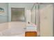 Bathroom showcasing a soaking tub, large window, and a separate glass enclosed shower at 16386 W Sierra St, Surprise, AZ 85388