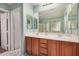 Bathroom displaying a double vanity, a framed mirror, and tile flooring at 16386 W Sierra St, Surprise, AZ 85388