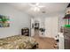 Bedroom featuring a ceiling fan, double-door closet, and an en-suite bathroom at 16386 W Sierra St, Surprise, AZ 85388
