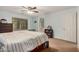 Bright bedroom featuring a ceiling fan, a large window, and a connecting bathroom at 16386 W Sierra St, Surprise, AZ 85388