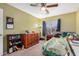 Cozy bedroom featuring a ceiling fan, natural light, and warm-colored walls at 16386 W Sierra St, Surprise, AZ 85388