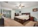 Spacious primary bedroom featuring a ceiling fan, walk-in closet and an ensuite bathroom at 16386 W Sierra St, Surprise, AZ 85388