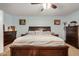 Primary bedroom with ceiling fan, and matching bedside tables and dressers at 16386 W Sierra St, Surprise, AZ 85388