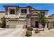 Charming two-story home with neutral stucco, stylish grey accents and a well-manicured, low maintenance front yard at 16386 W Sierra St, Surprise, AZ 85388
