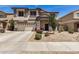 Charming two-story home with neutral stucco, stylish grey accents and a well-manicured, low maintenance front yard at 16386 W Sierra St, Surprise, AZ 85388