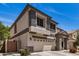 Charming two-story home with neutral stucco, stylish grey accents and a well-manicured, low maintenance front yard at 16386 W Sierra St, Surprise, AZ 85388