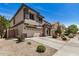 Charming two-story home with neutral stucco, stylish grey accents and a well-manicured, low maintenance front yard at 16386 W Sierra St, Surprise, AZ 85388
