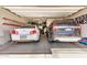 Spacious garage with two cars, ladder, tools, and storage; room for all your projects at 16386 W Sierra St, Surprise, AZ 85388