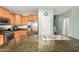 Eat-in kitchen featuring granite counters, stainless appliances, and natural wood cabinetry at 16386 W Sierra St, Surprise, AZ 85388